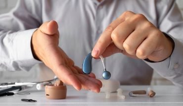 front-view-man-holding-hearing-a