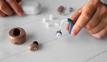 high-angle-hand-holding-hearing